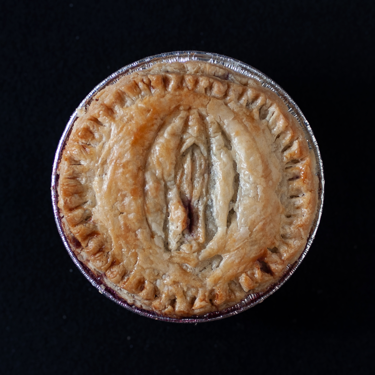 Baked version of pie number 8, a top view of vulva pie art 