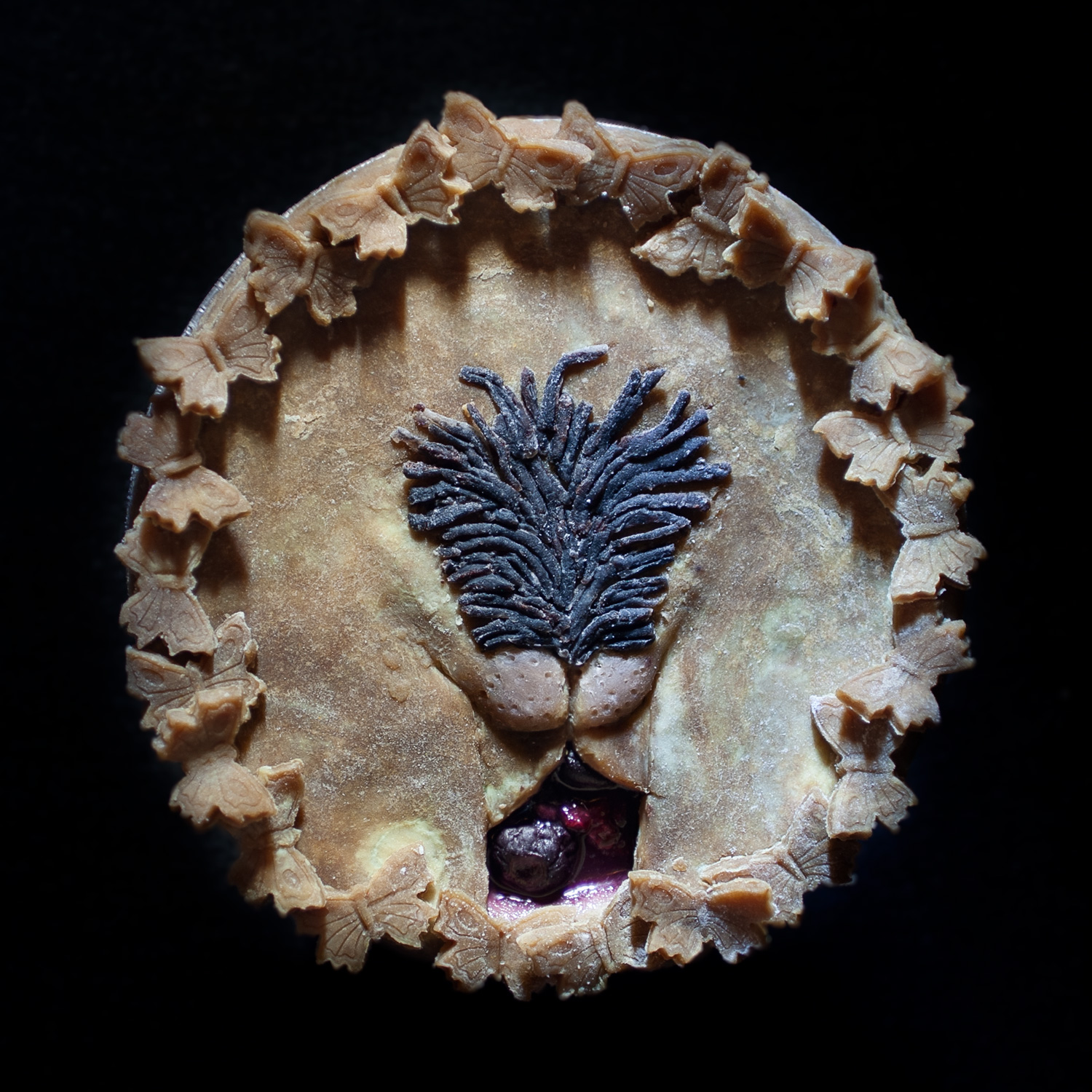unbaked six inch cherry berry berry pie with hand sculpted pie crust art made to look like a vulva with exposed labia majora and brown, pubic hair