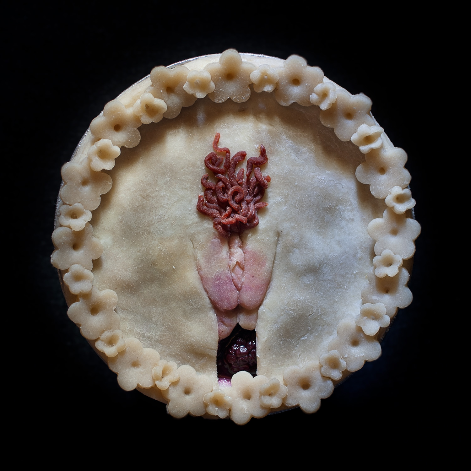 Unbaked six inch Cherry berry berry pie with hand sculpted pie crust art depicting a vulva with red pubic hair