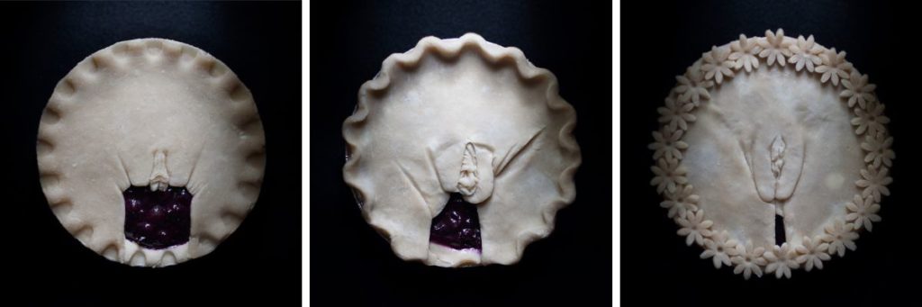 Full frontal vulva pie art showing 3 pies hand sculpted to look like human vulvas.