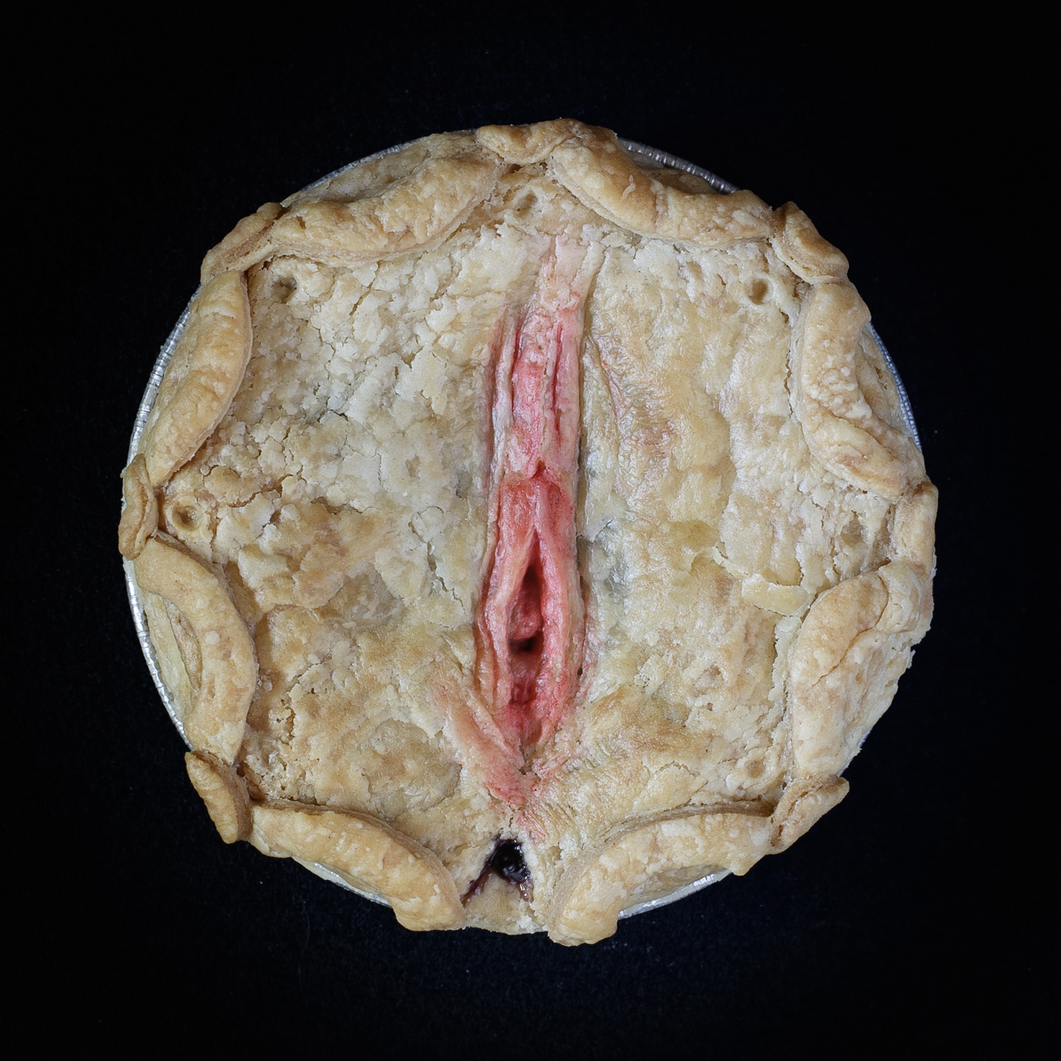 Baked Blueberry Pie with pie crust art made that looks like a pink vulva. 
