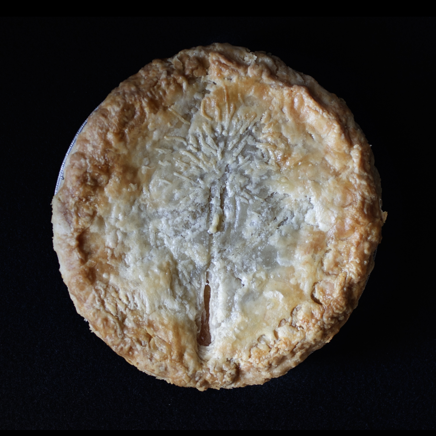 Baked pie with hand sculpted art made to look like a vulva